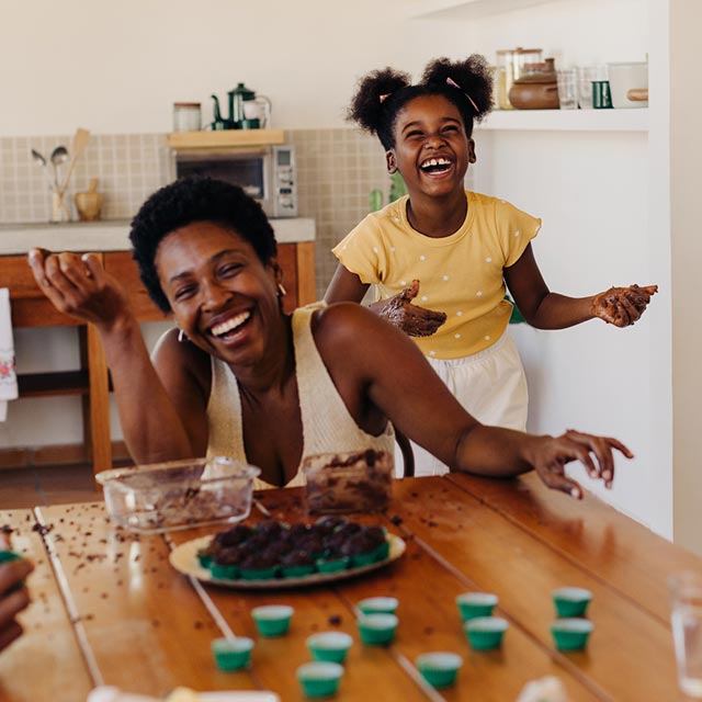 Mom and child having fun in the kitchen.