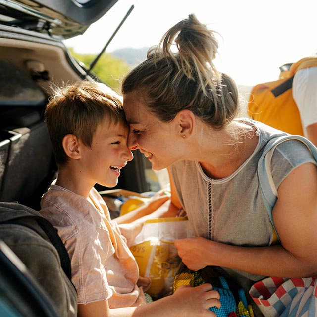 Mom and child in the back of a car.
