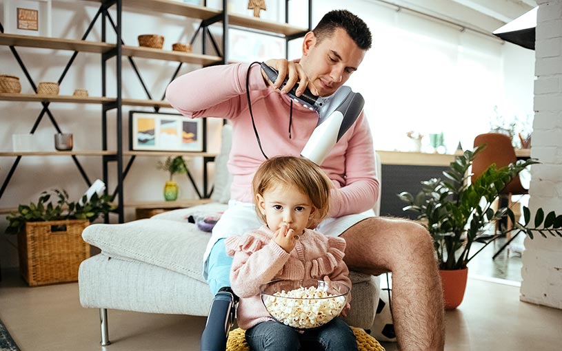 Father doing daughters hair at home
